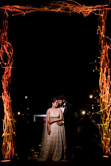Photo of Couple in a gold lehenga and black tuxedo for their sangeet