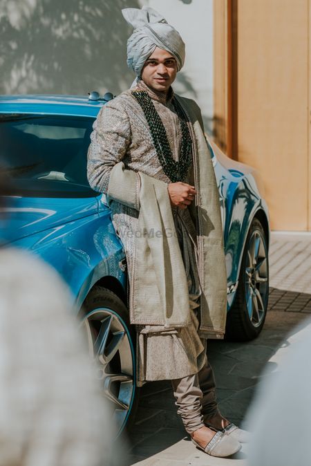 Photo of groom sherwani with in sage green with darker necklace