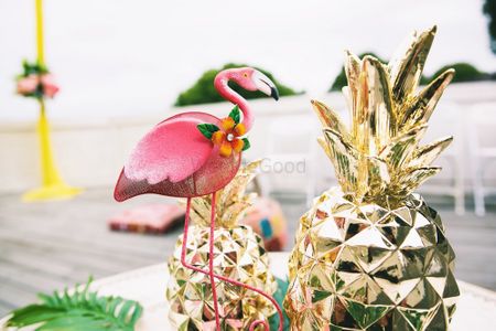 Photo of Tropical theme pineapple and flamingo centrepieces