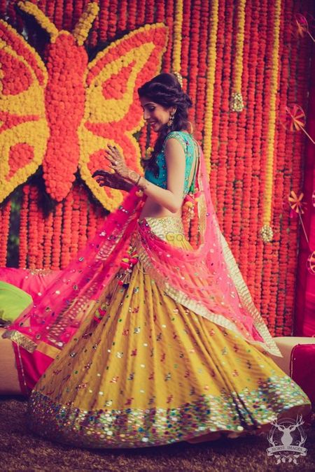 Photo of bright colorblocked lehenga in leheriya yellow pink and blue with mirror work detailing