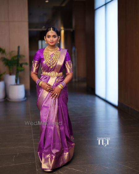 Stunning aubergine silk saree with layered gold jewellery for this south indian bridal look 
