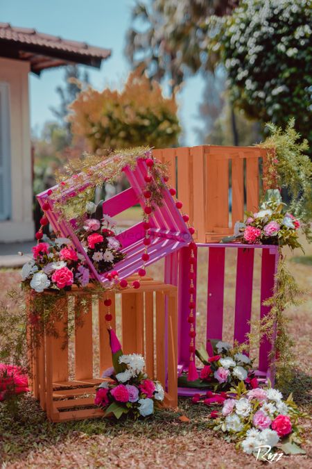 DIY decor with hand-painted wooden crates and flowers.
