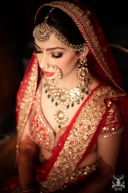Photo of Bride Wearing Polki Bridal Jewellery with Green Stones