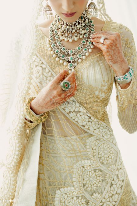 Photo of Stunning bridal jewellery shot with diamond and emerald polki and jadau jewellery