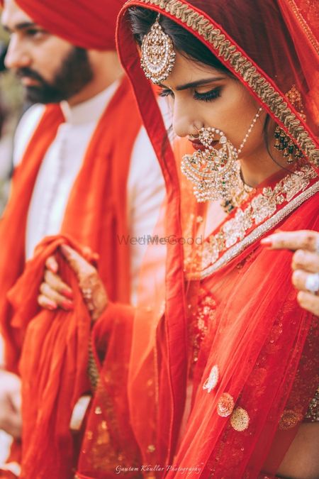 Photo of Bridal portrait with bride wearing oversized Nath