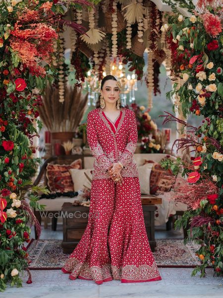 Photo of Stunning jacket style red sharara for the mehendi with gold jewellery