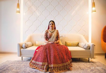 Photo of Pretty bride wearing red and golden lehenga