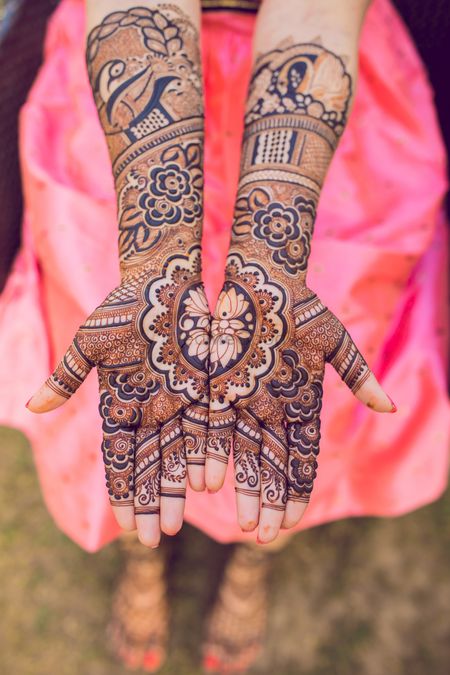 A traditional hand Mehndi with intricate design. 