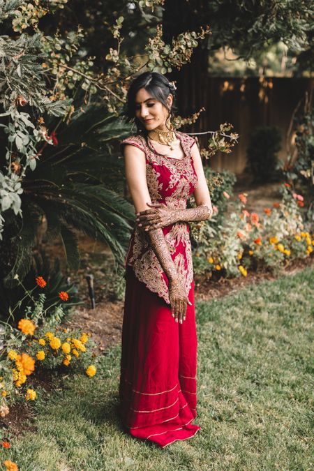 Mehendi sharara outfit with red and dull gold work