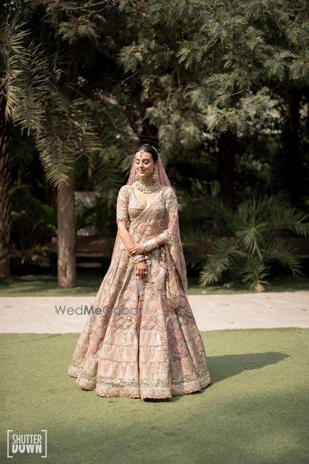 Photo of bride in pastel bridal lehenga