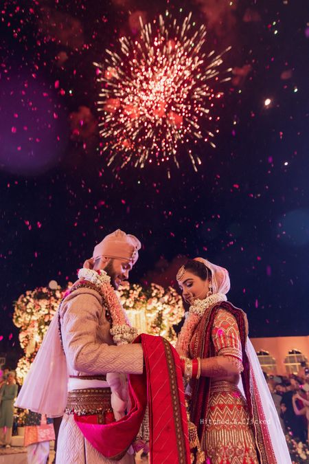 Photo of wedding dayh couple shot with firecrackers