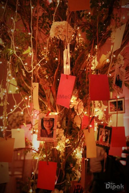 Photo of Indoor Wishing Tree with Suspended Lights and Photos
