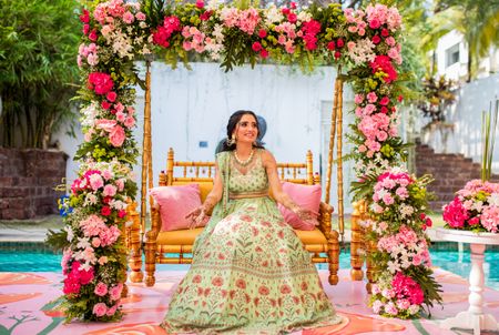 Bride on a floral swing for mehendi