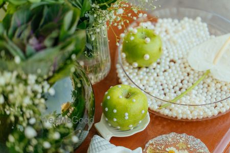 Unique decor elements with fruits and pearls in decor for this forest theme haldi