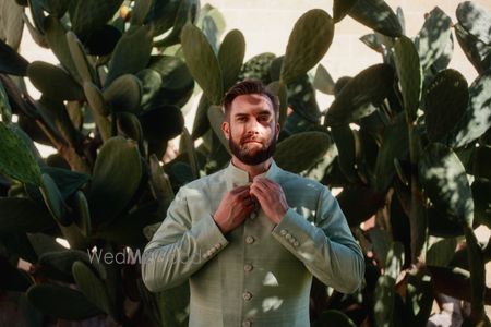 Groom in a stunning sage green sherwani for his wedding day