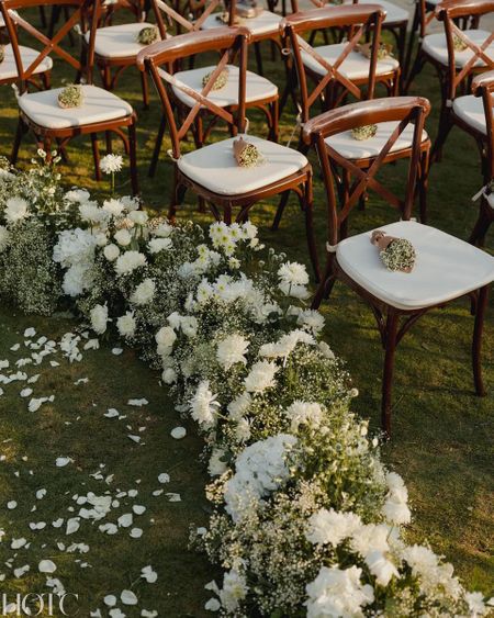 Photo of Lovely all white aisle decor with baby breath and wooden chairs
