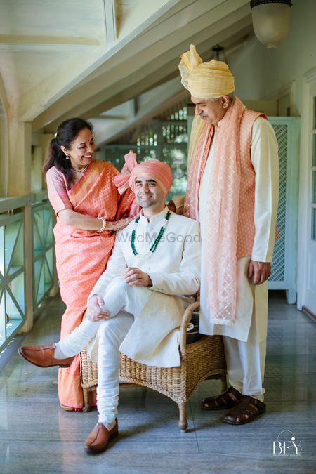Groom posing with his parents 