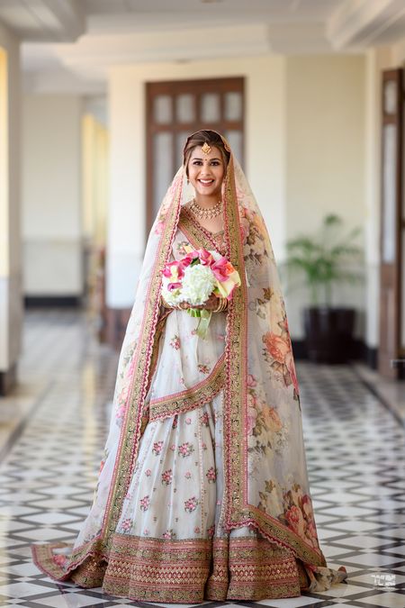 Bride in a beautiful white and pink floral lehenga