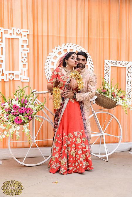 Photo of Red and gold bridal lehenga with floral print dupatta