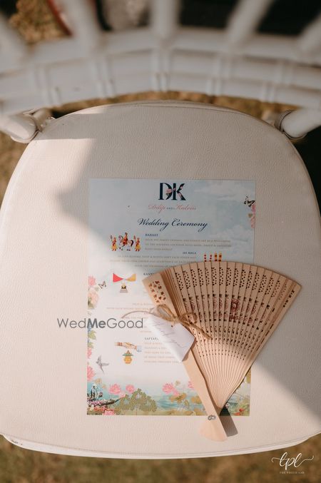 Photo of Cute fans and wedding ceremony details on the chair for guests on the wedding day