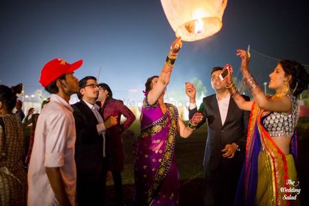 Releasing sky lanterns into the air as the couple sits on the feras