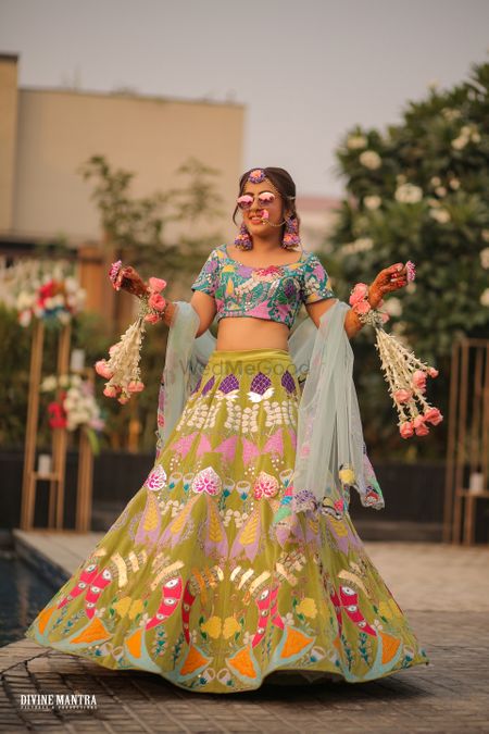 bride wearing multicolour patchwork lehenga by aisha rao on mehendi