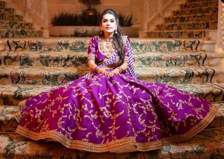 A bride in a purple outfit for her sangeet