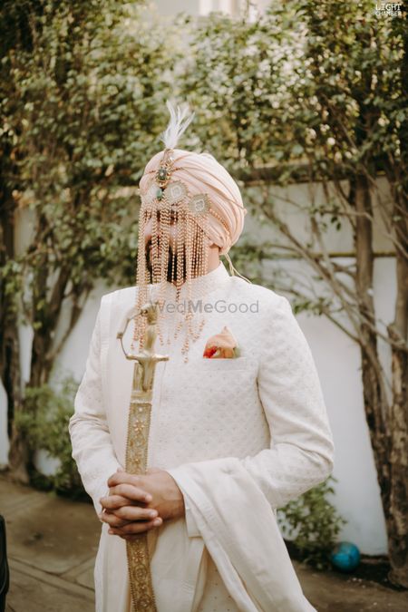 sikh groom wearing sherwani with shera