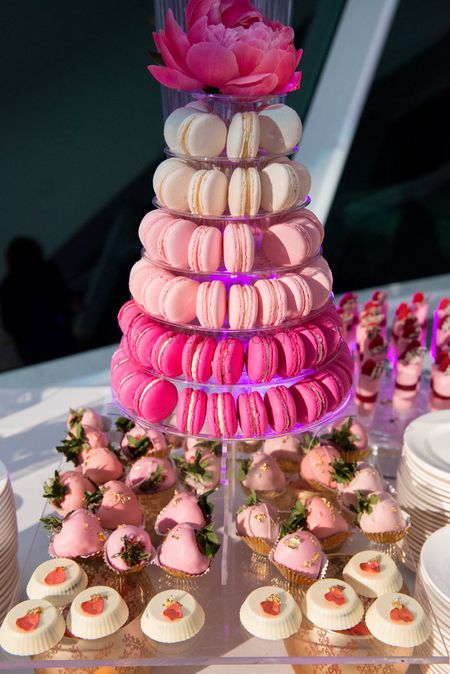 Photo of Macroons and Cupcakes on Display at Food Counter