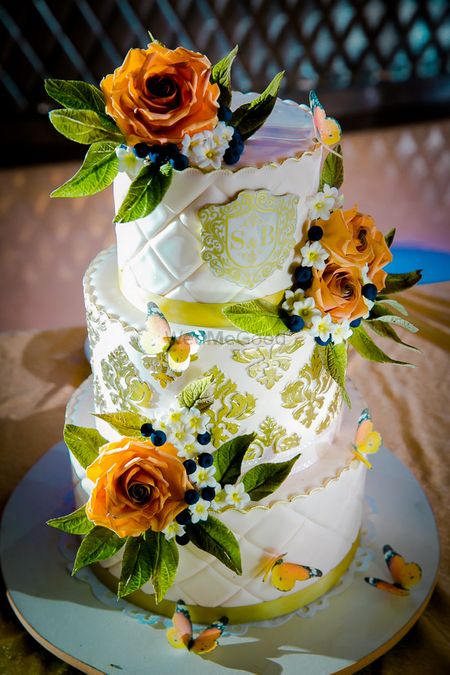 White and yellow wedding cake by Firefly