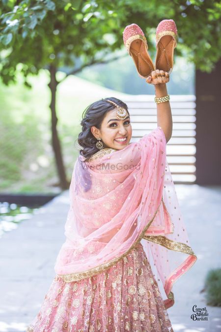 A bride to be in a baby pink outfit for her mehndi
