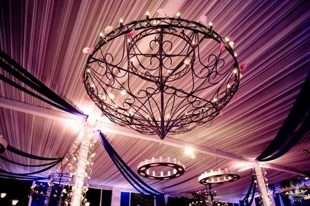 glamorous ceiling decor with wrought iron chandeliers and candles