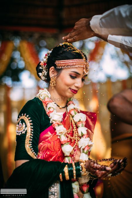 A south Indian bride with a contrasting blouse and golden design on the sleeves