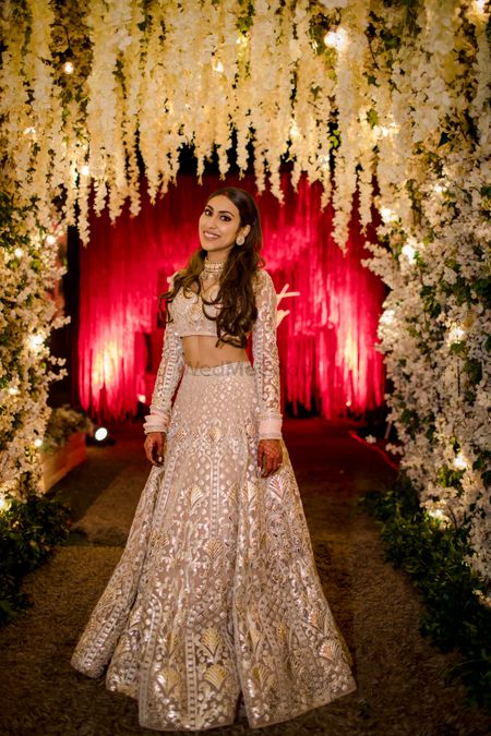 Bride dressed in an ivory & silver lehenga for the reception.