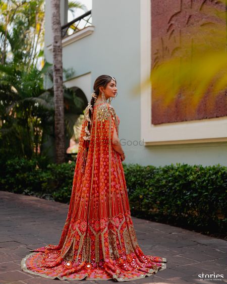 Photo of Stunning ornage and pink phulkari cape outfit with a gajra braid for the mehendi