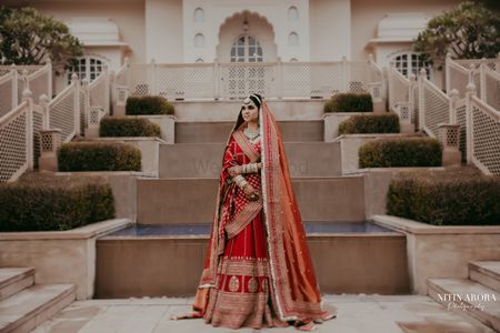Photo of bride in red and gold sabyasachi lehenga