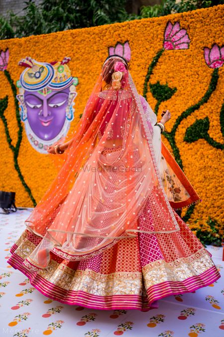 twirling bride shot in a panelled wedding lehenga 