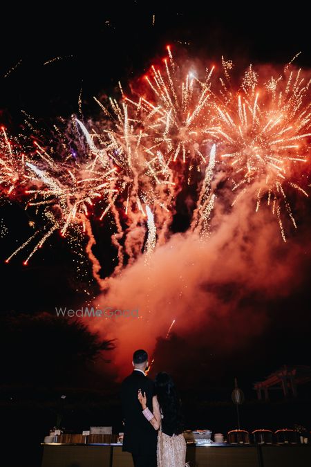 Gorgeous shot of the couple with statement fireworks at the background