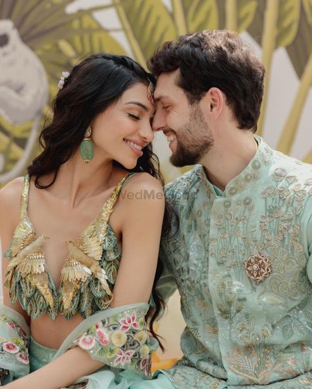 Photo of Alanna & Ivor in pastel outfits on their Mehendi