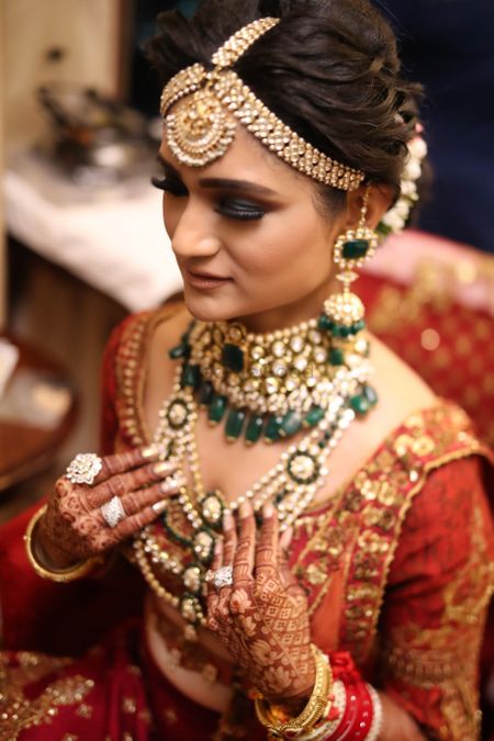 Bridal jewellery with layered necklaces and thick maangtikka 