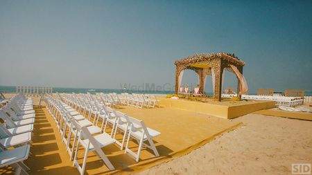 Photo of Beach wedding gold and white mandap with rose gold structure