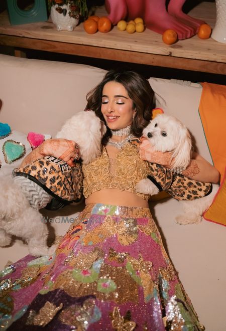 Cute capture of the bride with her two pet dogs wearing coordinated clothes