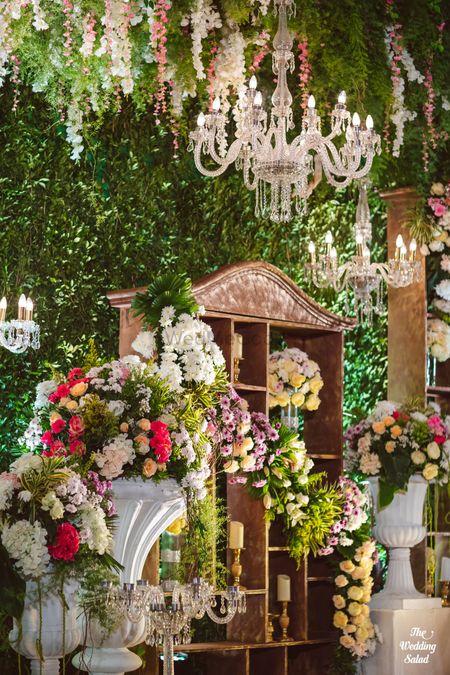 Photo of hanging floral decor and crystal chandelier for wedding