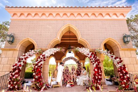 unique circular floral mandap idea with maroon and white flowers