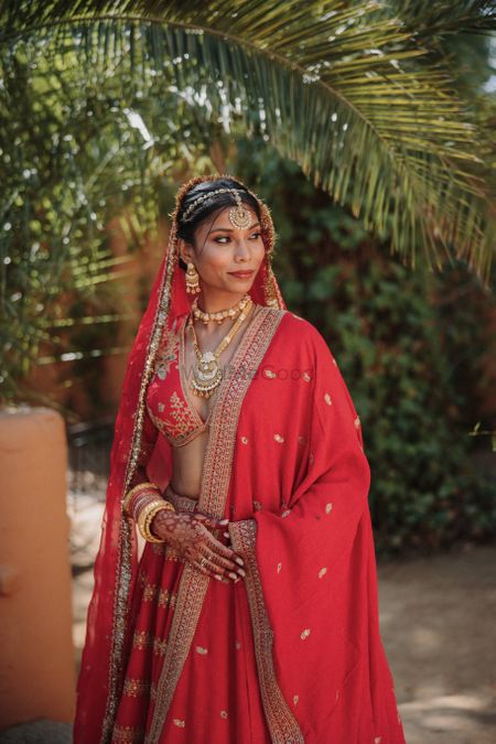 Photo of Bridal portrait with bride in red lehenga