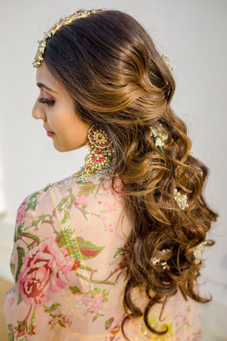 Photo of Bride with open hair on her mehendi