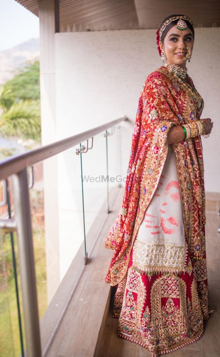 unique red and white bridal lehenga with handprints