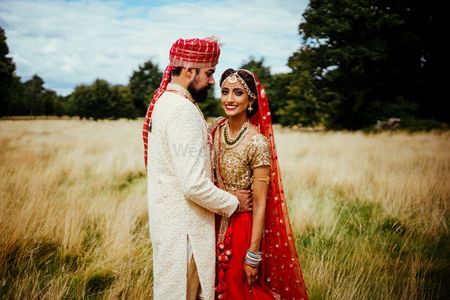 Bride in red and gold lehenga