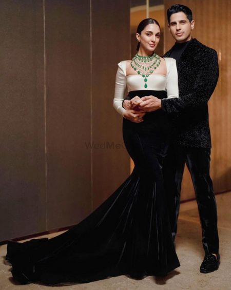 Photo of kiara advani on her reception wearing a manish malhotra fishcut gown and an emerald necklace