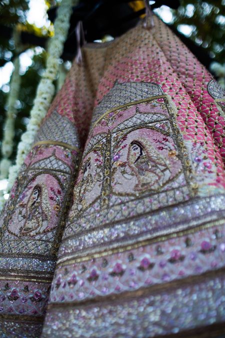 Light pink bridal lehenga with unique embroidery on it 